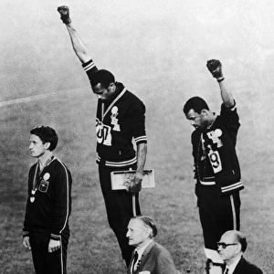 OLYMPIC GAMES, 1968. American runners Tommie Smith (center) and John Carlos (right)